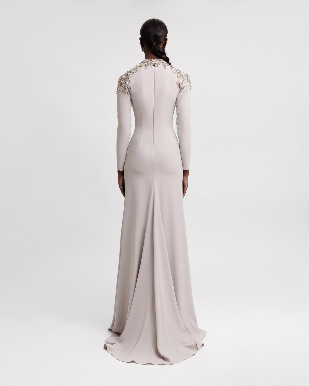 The back of a long-sleeve greige evening dress featuring embellished collar and shoulder.