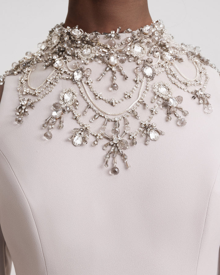 A close-up of an embellished collar greige evening dress.