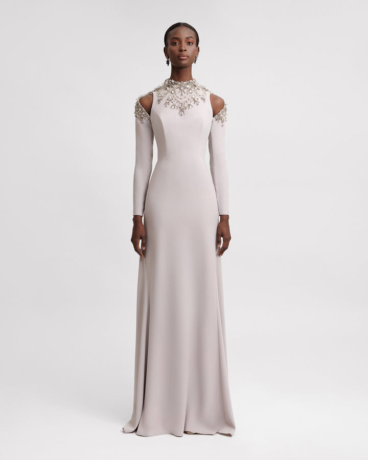 A long-sleeve greige evening dress featuring embellished collar and shoulder cut-outs.