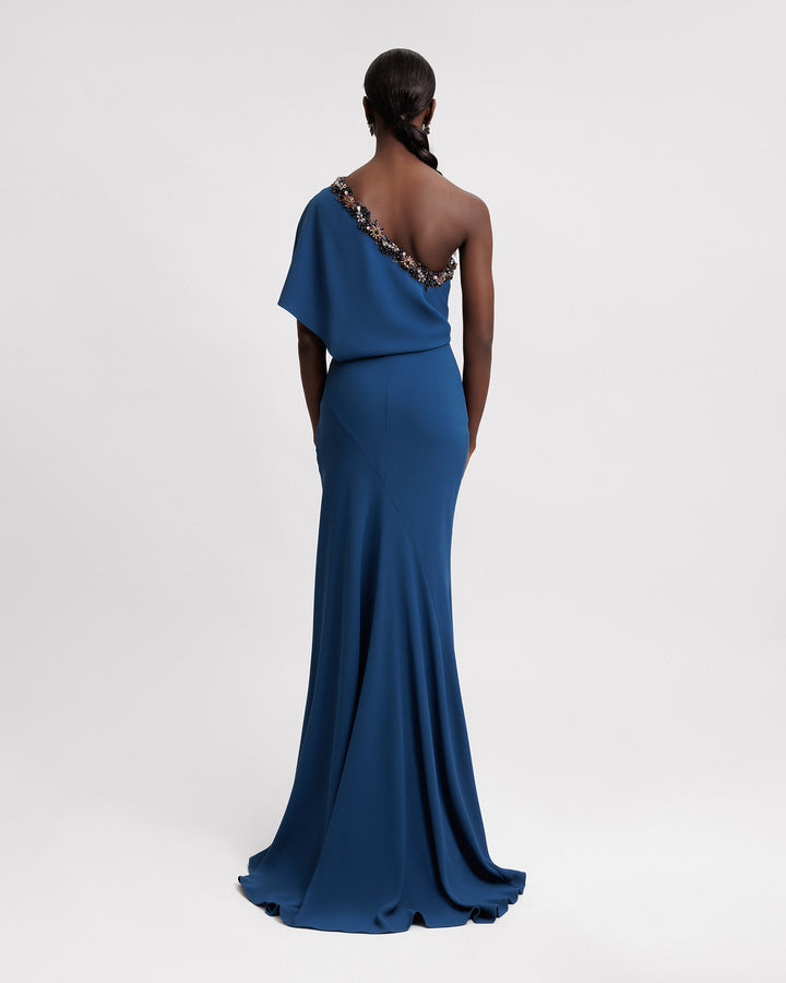 The back of a long evening dress featuring a beaded one-shoulder cut.