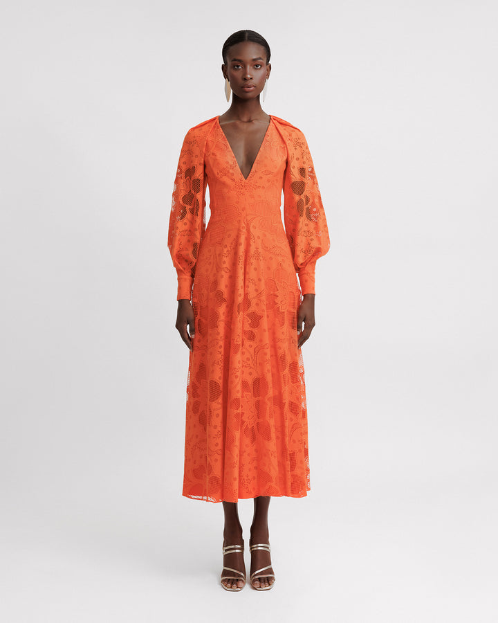 A v-neckline orange lace midi dress with draped bishop sleeves.