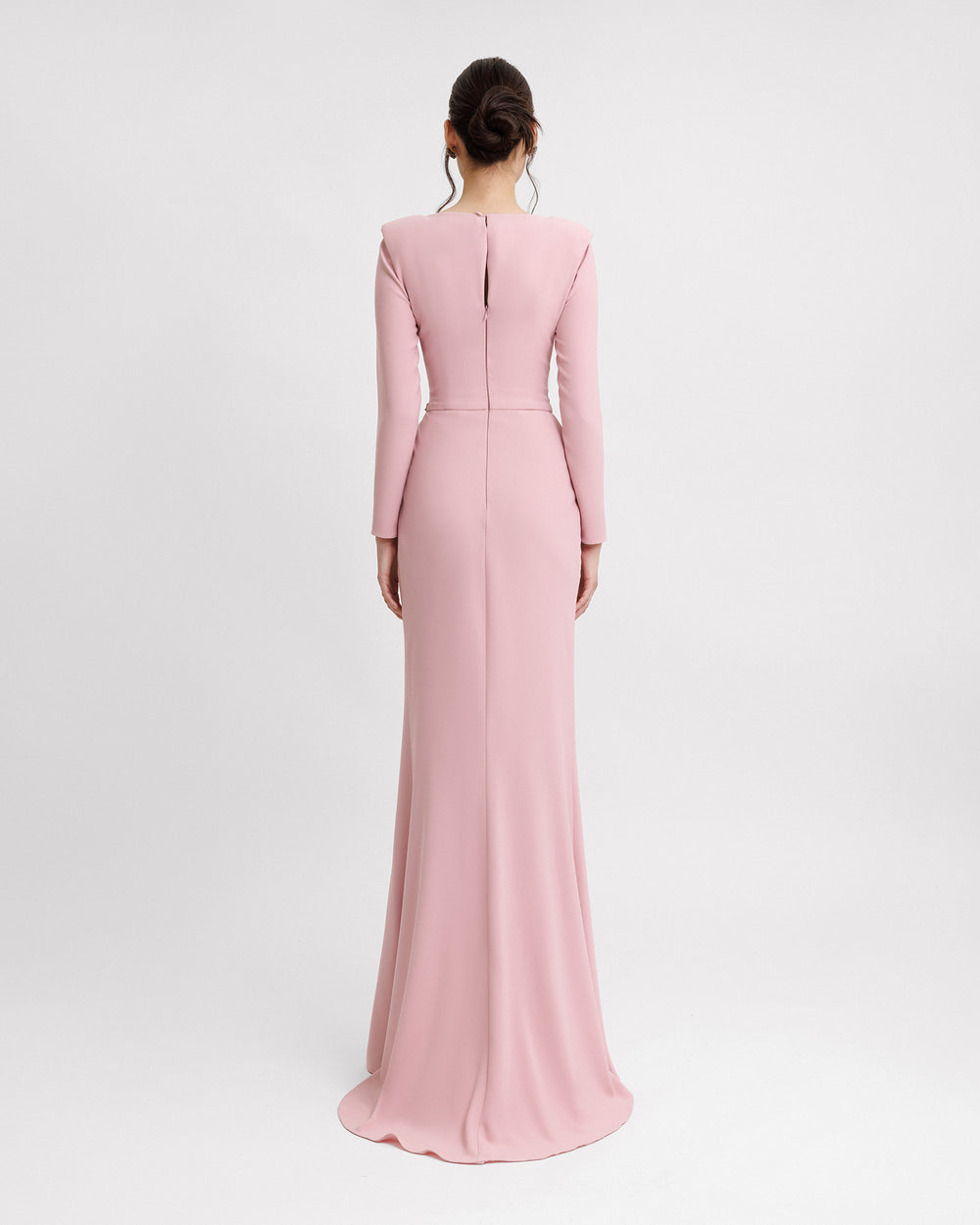 The back of a long sleeved slim-cut evening dress in pink color.