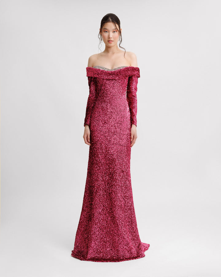 A fully sequined off-the-shoulders evening dressing fuchsia with a beaded heart shaped neckline and long sleeves.