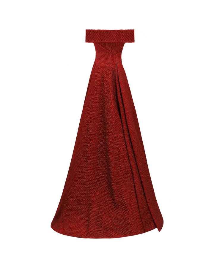 The back of an off-the-shoulders red evening dress with an asymmetrical waistline and draped flared skirt.