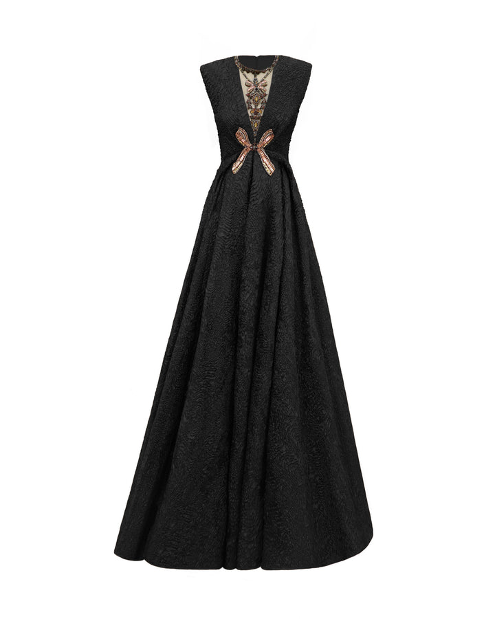 An embellished V-neckline black dress with structured shoulders and a draped flared skirt.