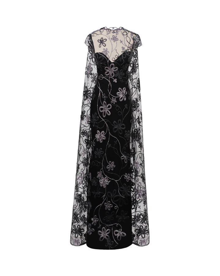 A long floral embroidered tulle black evening dress with a cape-like back.