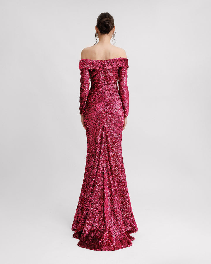 The back of a fully sequined off-the-shoulders evening dressing fuchsia with long sleeves.