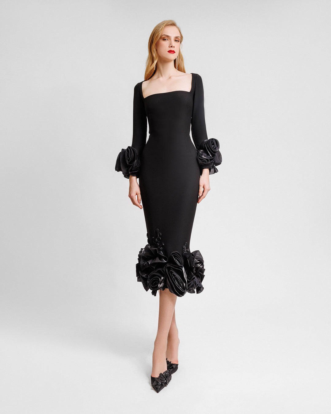 A long sleeved squared-neckline midi dress in black crepe featuring floral cuffs and hemline.