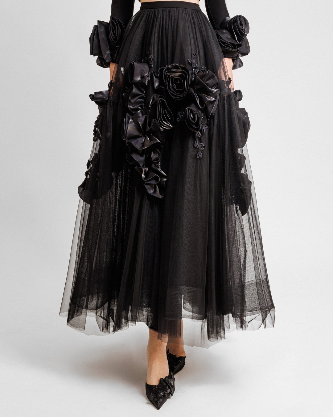 A black tulle evening skirt with floral draping.