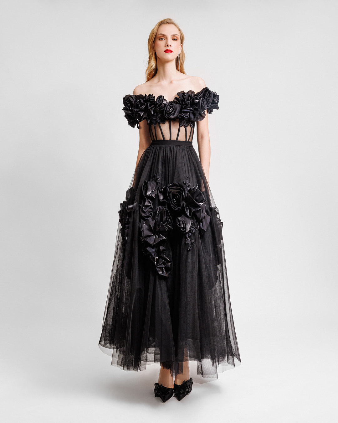 A black midi dress with off-the-shoulders draped florals featuring a see-through corset and flared tulle skirt with floral draping.