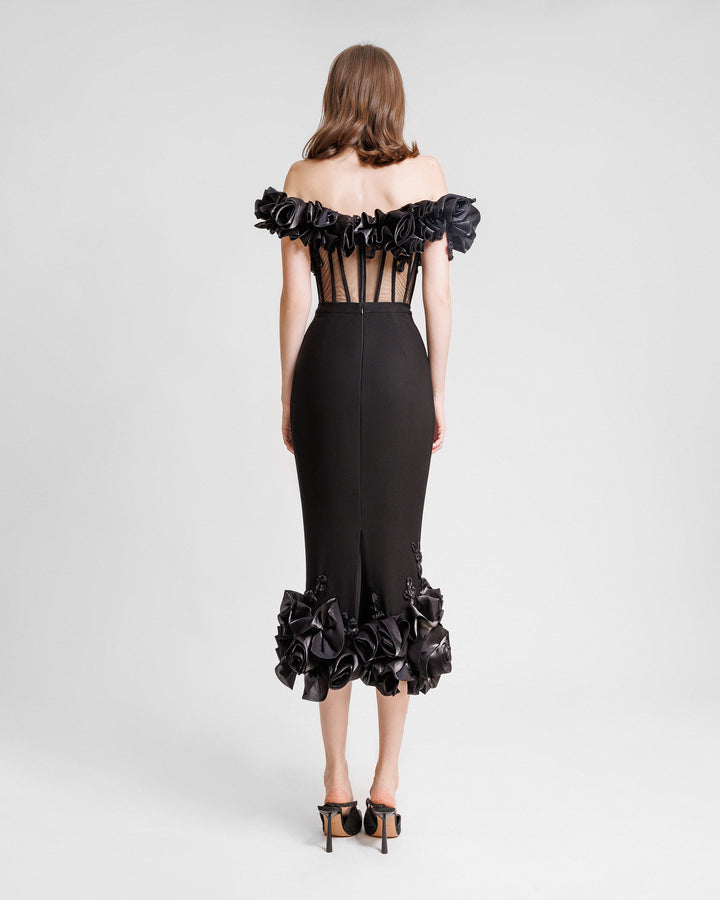 The back of an evening wear set featuring an off-the-shoulders draped floral see-through corset paired with a midi skirt with draped florals on the hemline.