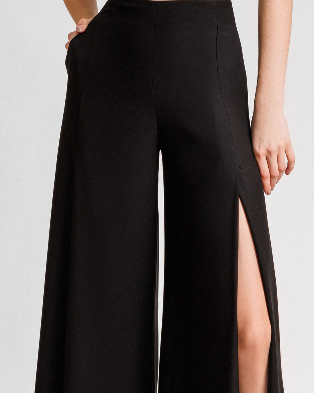 A straight-cut black pants with slits on the sides.