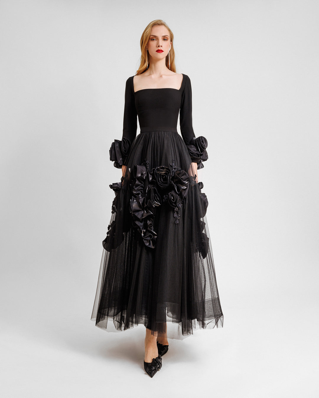 A midi evening dress featuring a squared-neckline crepe top gathered with a midi tulle skirt adorned with floral cuffs and and embellishments on the skirt.