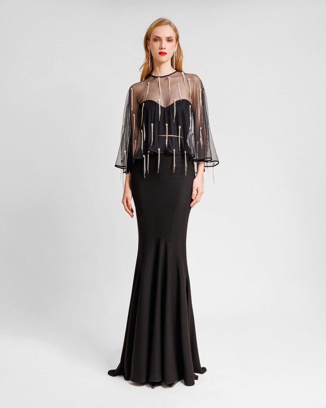 A black evening wear featuring a tube top with a beaded tulle overlay paired with a long slim-cut skirt.