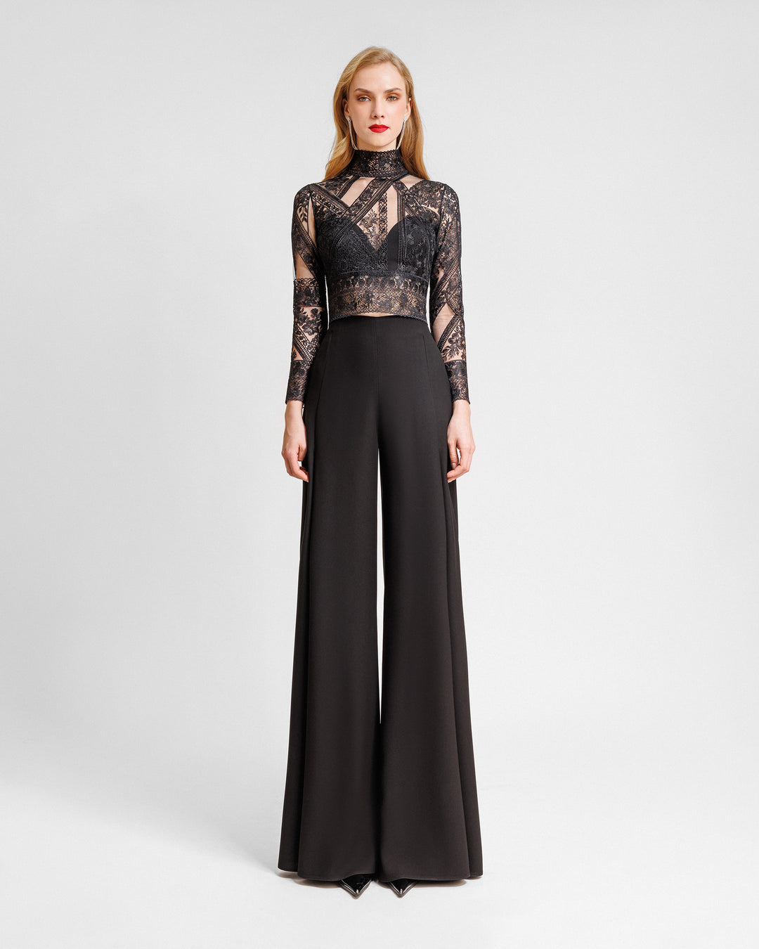 A black evening wear set featuring a Long-sleeve patterned lace top paired with straight-cut pants with slits on the sides.