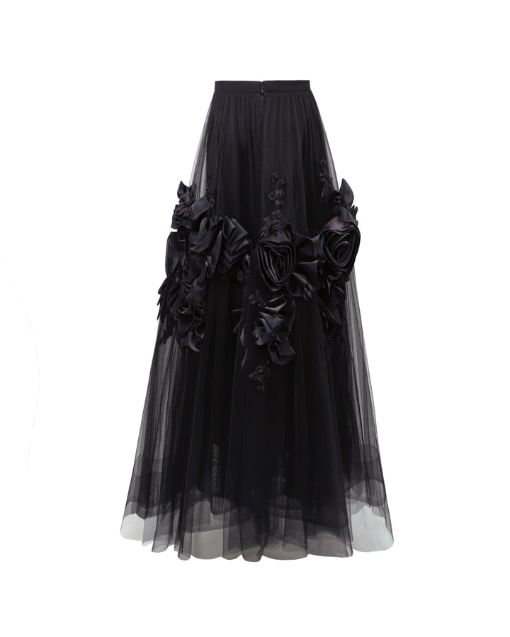 The back of a black tulle evening skirt with floral draping.