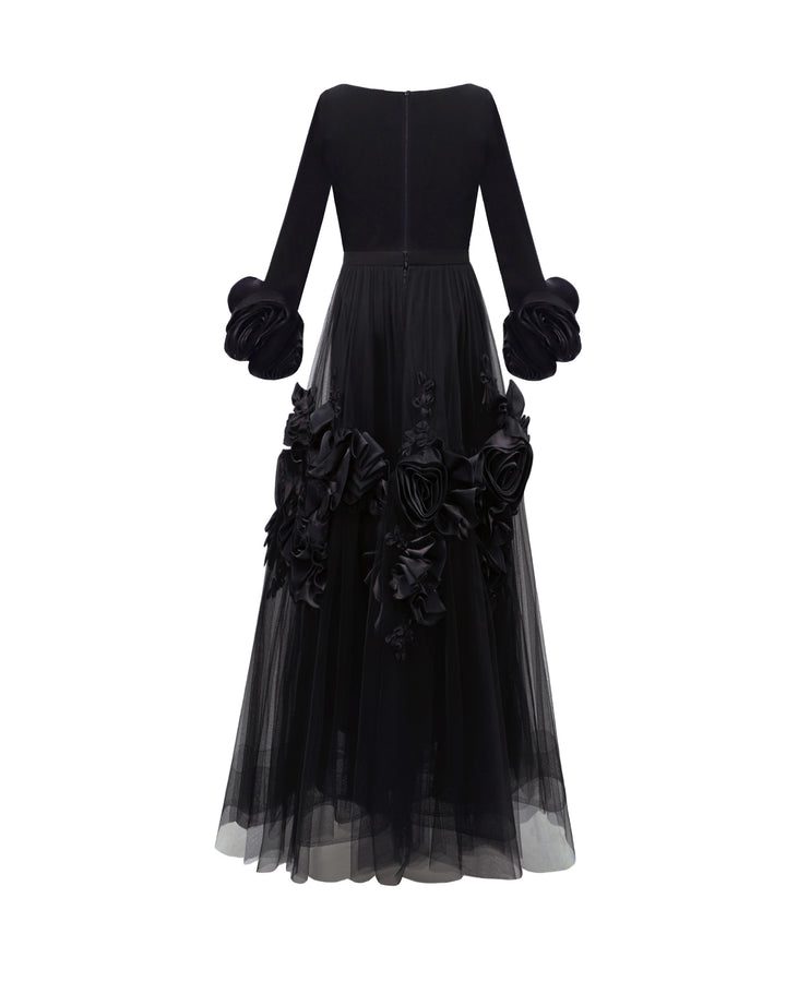 The back of a midi evening dress featuring a squared-neckline crepe top gathered with a midi tulle skirt adorned with floral cuffs and and embellishments on the skirt.