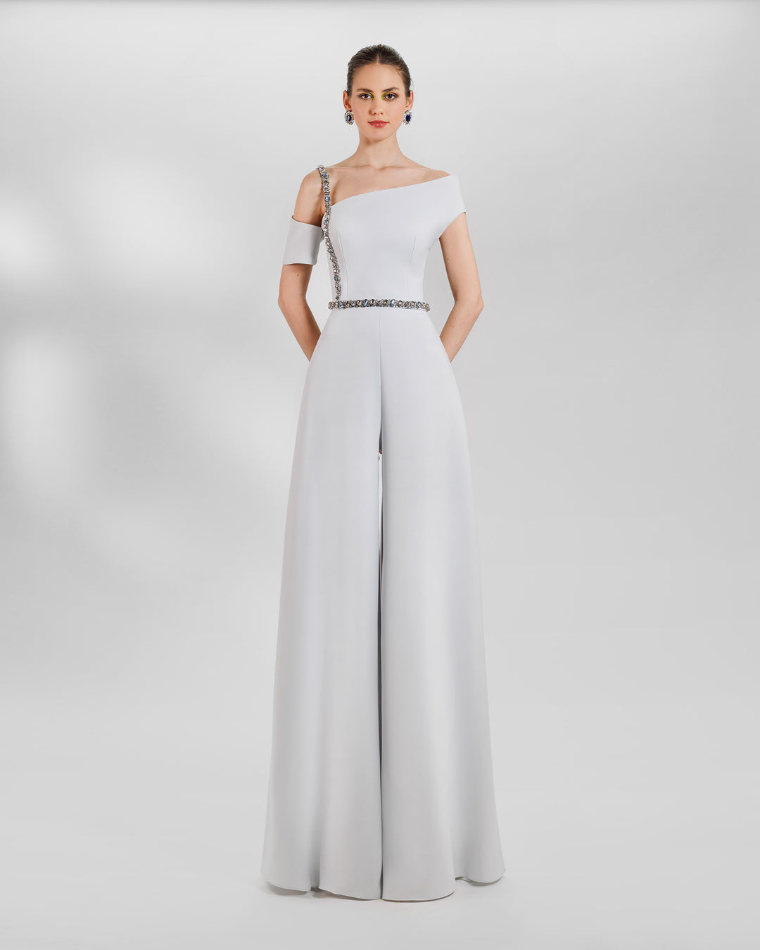 An occasion outfit featuring an asymmetrical neckline top with a beaded strap paired a wide high waist grey pants.