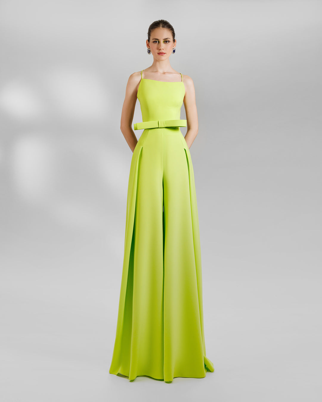 A colorful look Featuring a high-waist wide pants in lime color with side pleats, and an open laced back top featuring a big sharp bow design on the waist.