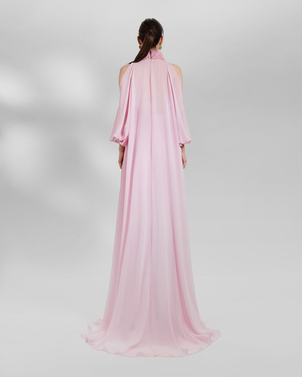 The back of an evening wear pink set featuring organza high-collar top with open shoulders and a long back, paired with wide high-waist pants.