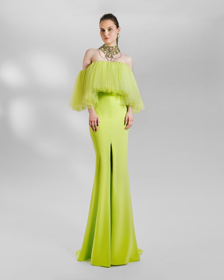 An evening look in lime color featuring an off-the-shoulders tulle top paired with a slim-cut skirt with a front slit. the look is completed with a matching beaded collar necklace.