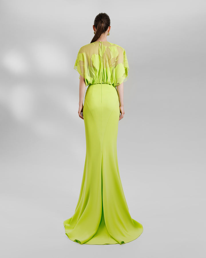 The back of a lime evening wear set featuring a patterned lace top matched with a mermaid-cut skit.