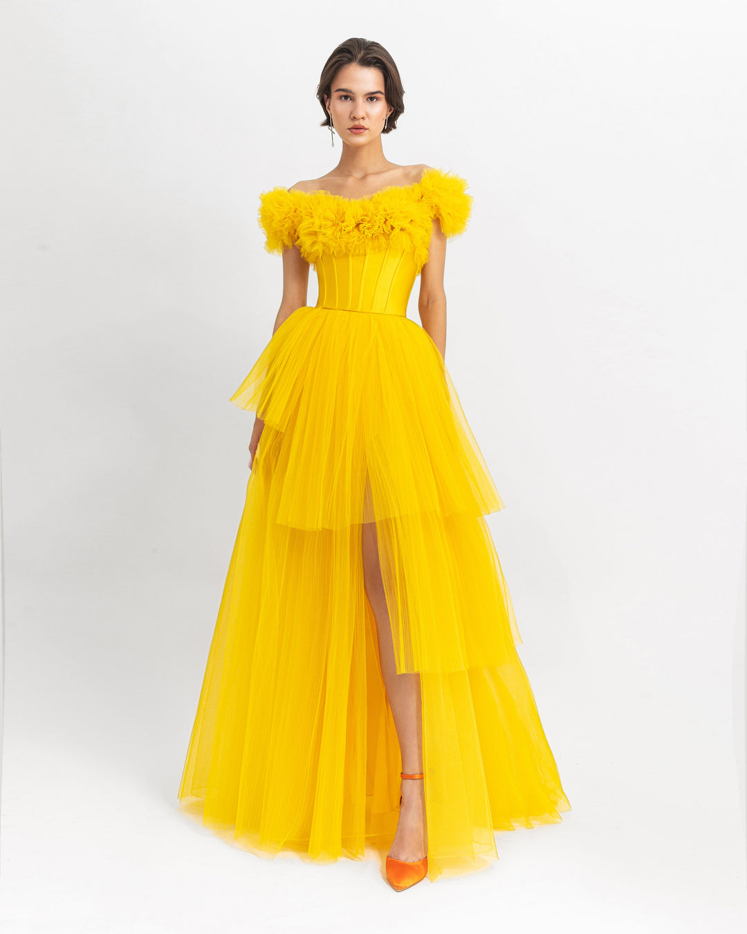 A ruffled off-shoulder corset long yellow evening dress with a fully pleated tulle lower part.