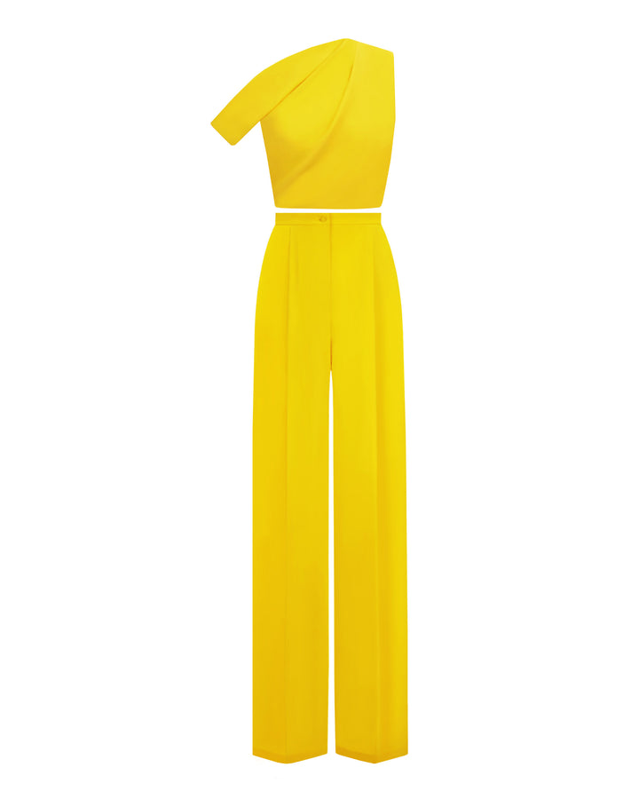 A yellow evening wear set featuring an asymmetrical cut crepe top with draping details, paired with a straight cut crepe pants.