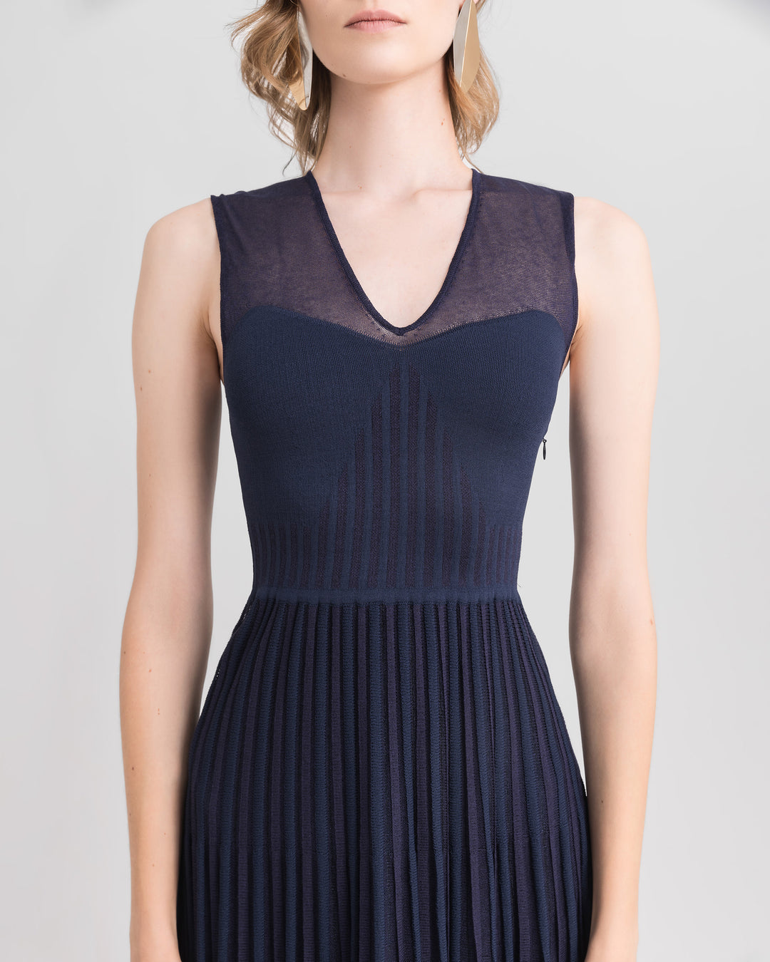 A close-up of a V-neckline with heart shape design knit midi dress in navy color.