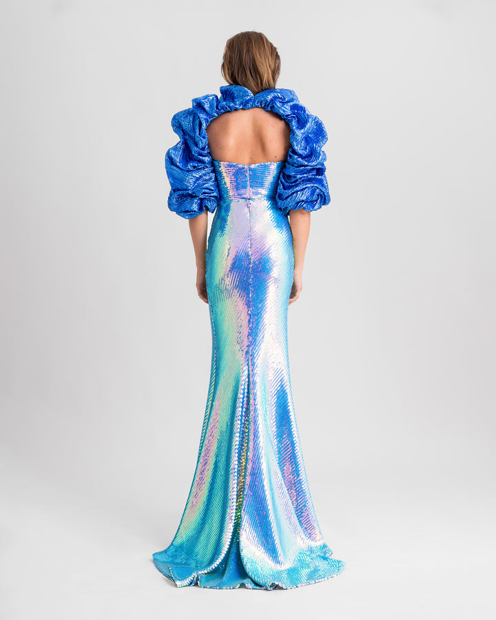 The back of an evening wear set featuring sequined tube top in aqua blue paired with a long skirt and a draped bolero.