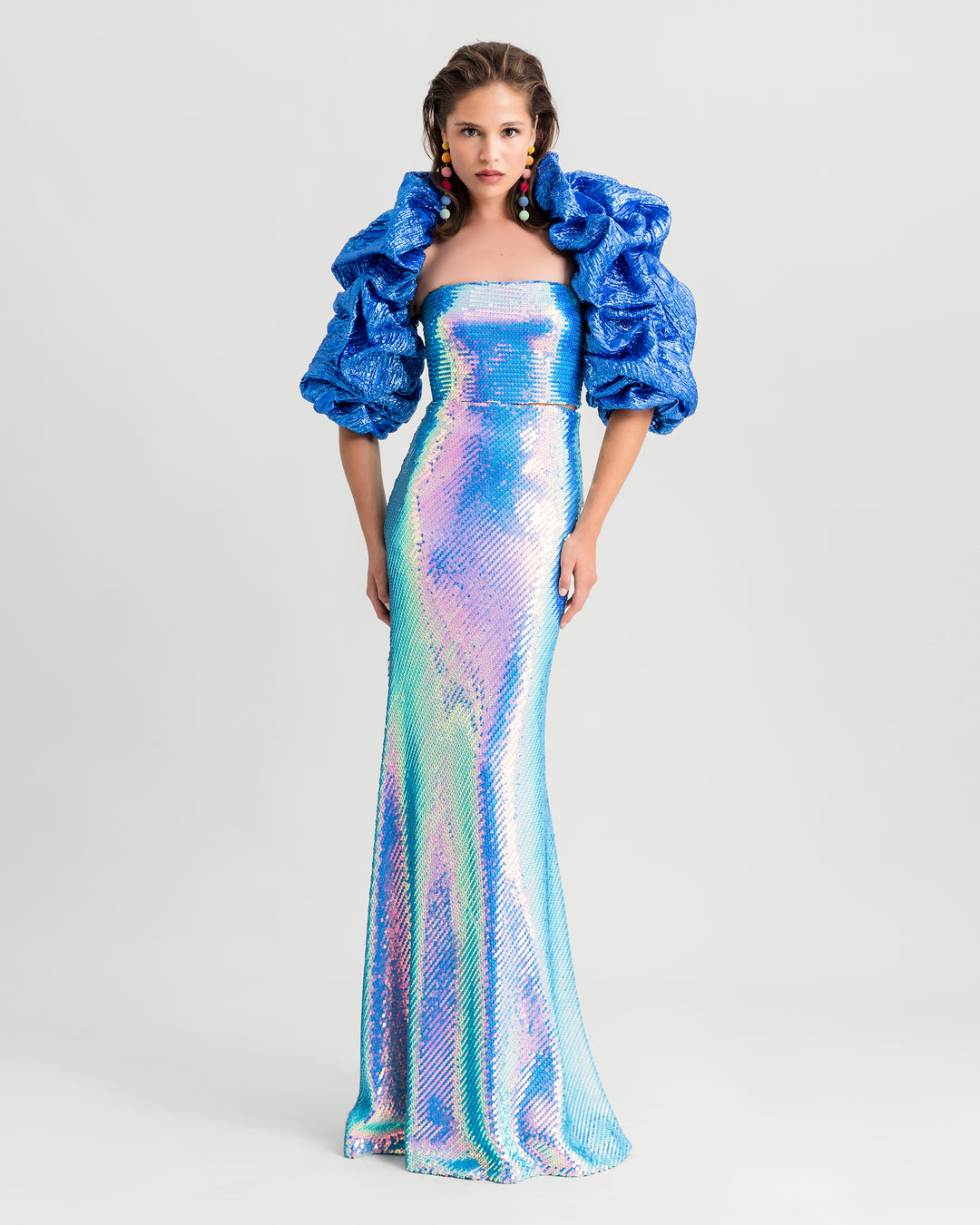 An evening wear set featuring sequined tube top in aqua blue paired with a long skirt and a draped bolero.