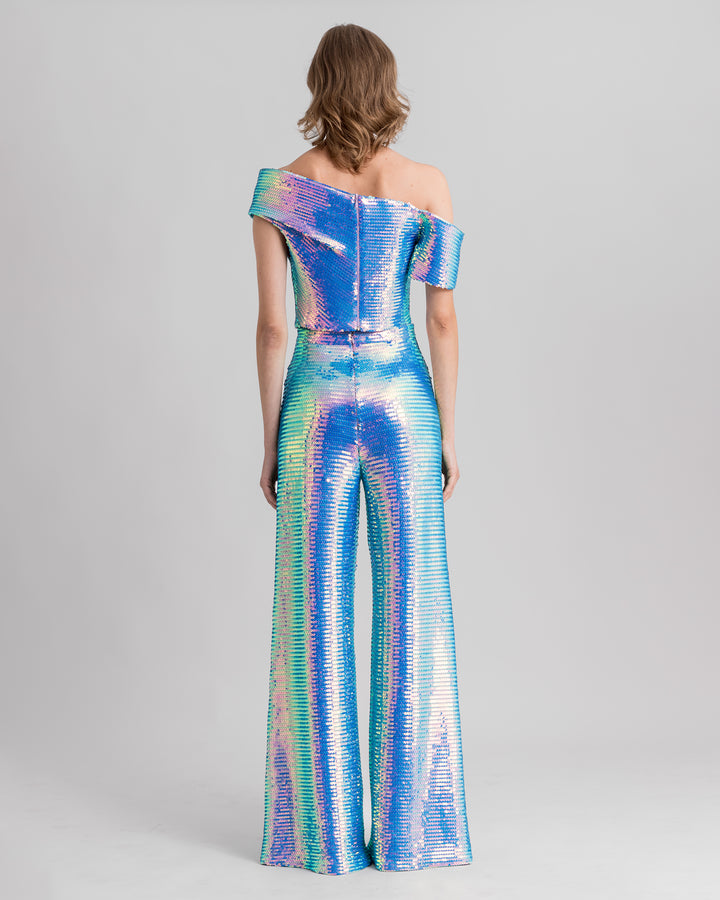 The back of a blue sequined evening wear set featuring an asymmetrical one-shoulder draped top paired with straight-cut pants.