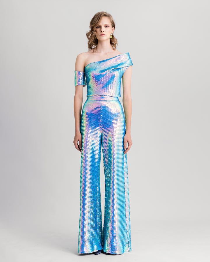 A blue sequined evening wear set featuring an asymmetrical one-shoulder draped top paired with straight-cut pants.