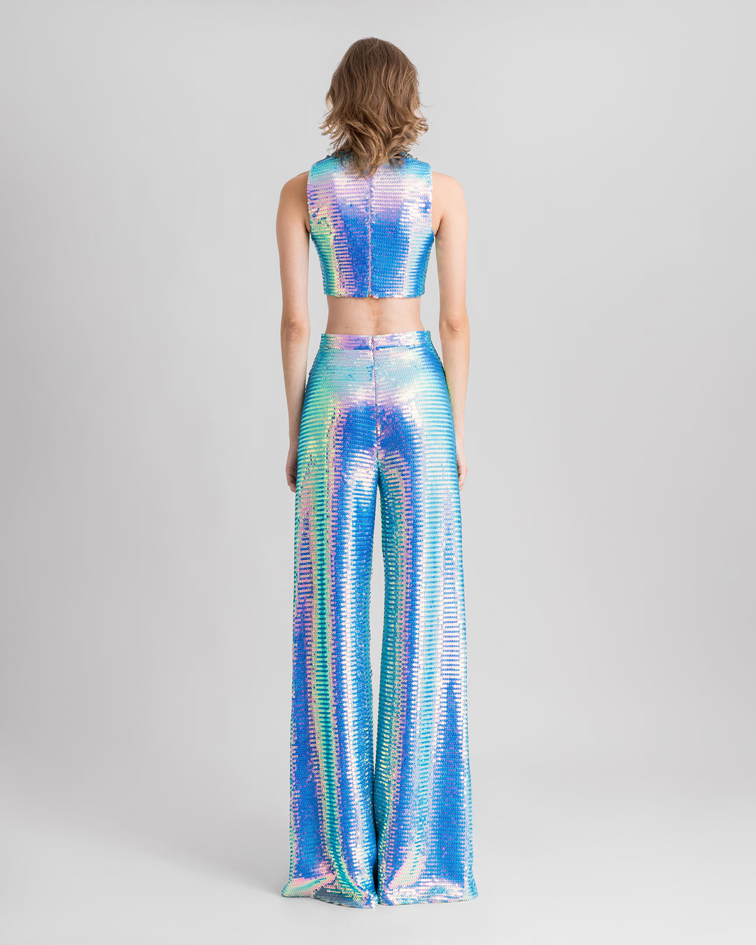 The back of a blue sequined evening wear set featuring a cropped-top paired with straight-cut pants.