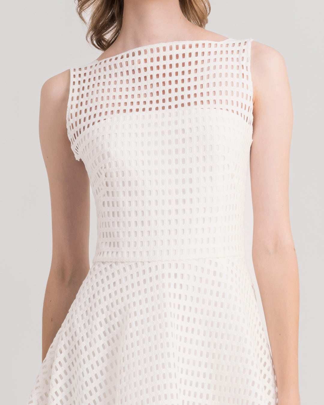 A close-up of an ivory crochet lace flared midi dress.