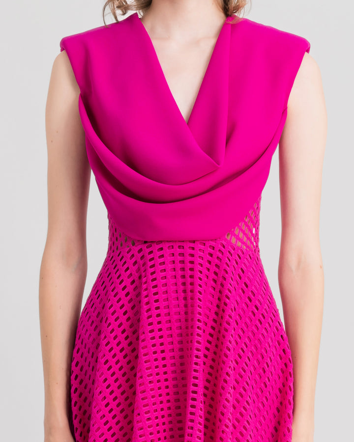 A close-up of a cowl-neckline fuchsia midi dress with crochet lace skirt.