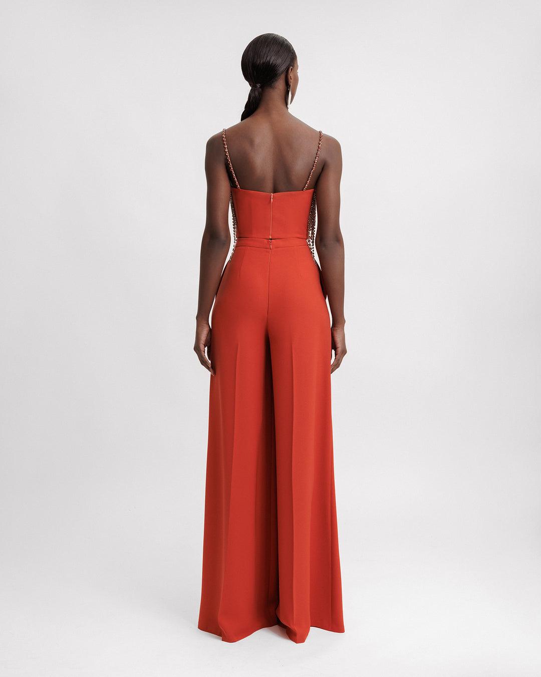 The back of an evening wear set featuring a cropped top paired with a flared pants.