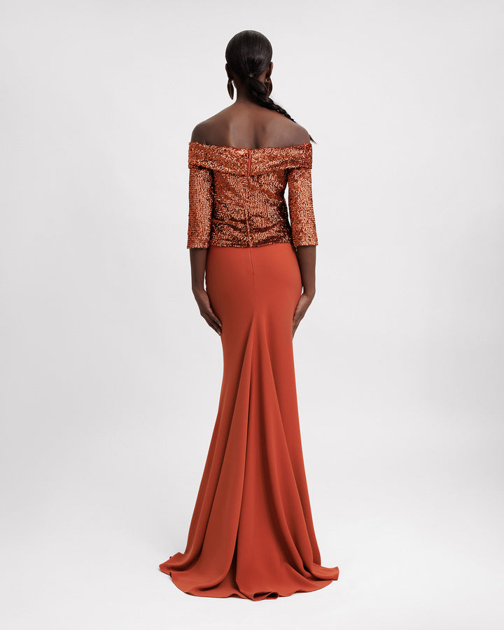 The back of an evening wear set featuring an off-the-shoulders copper sequins top paired with a slim-cut long crepe skirt.