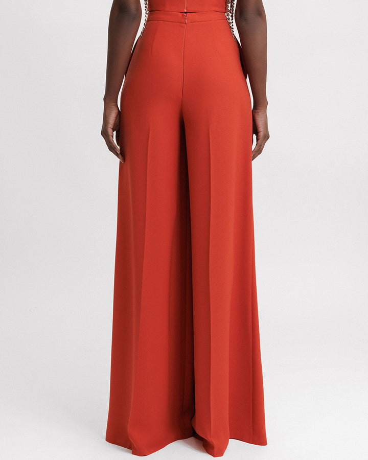 The back of an evening wear flared orange pants.