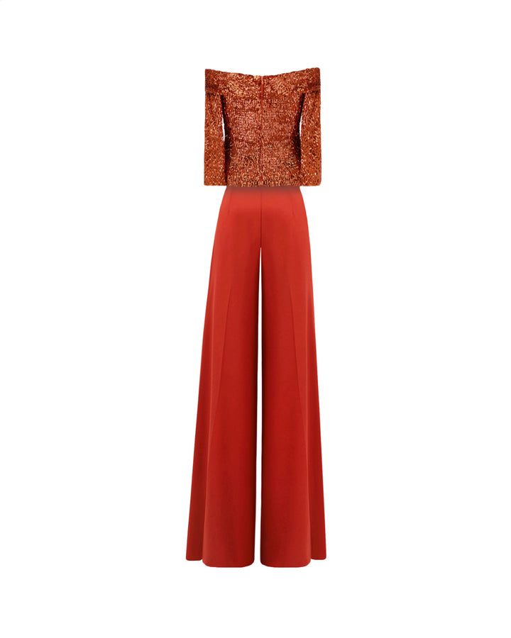 The back of an evening wear set featuring an off-the-shoulders copper sequins top paired with a flared pant.