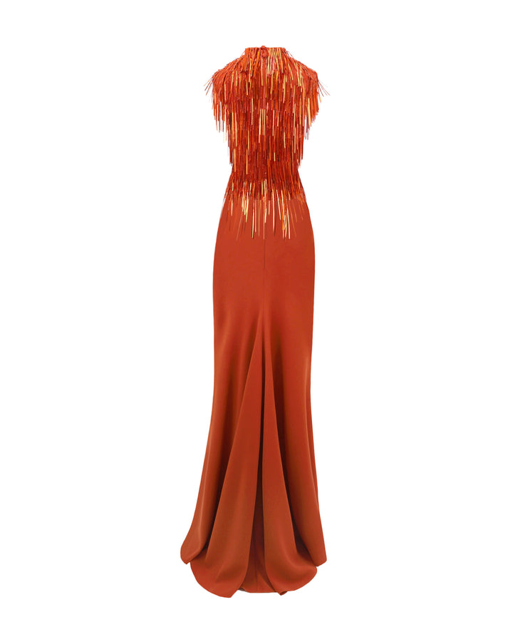 The back of an evening wear set featuring a high-collar beaded fringes top in copper color paired with a slim-cut crepe long skirt.