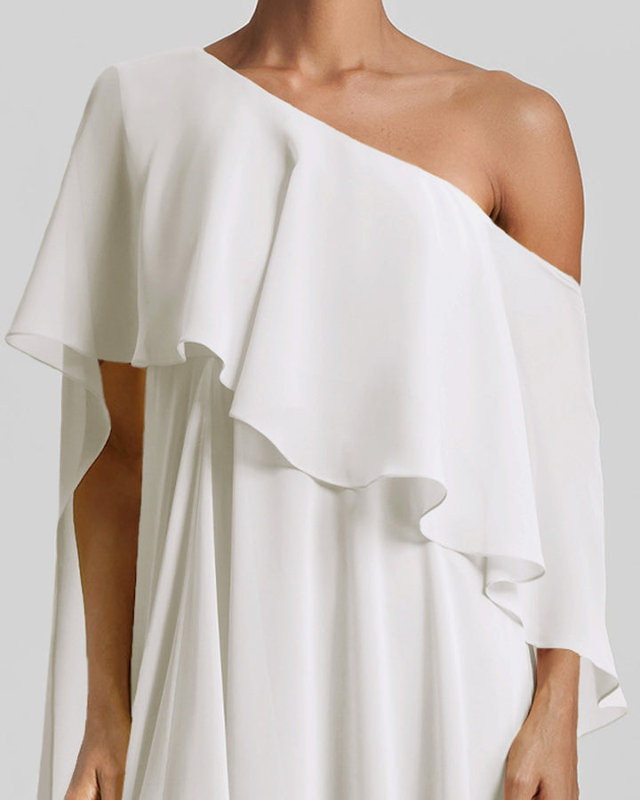 A close-up of a one-shoulder ivory dress featuring a ruffled cape-like sleeve.