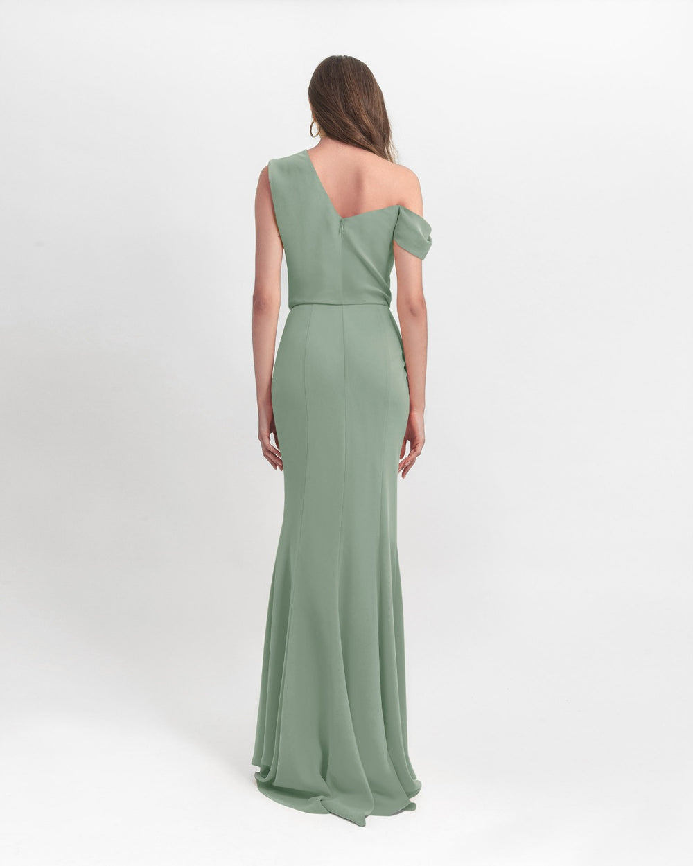 The back of an asymmetrical cut crepe long mint green dress with draping details on the upper part and a slim cut skirt.