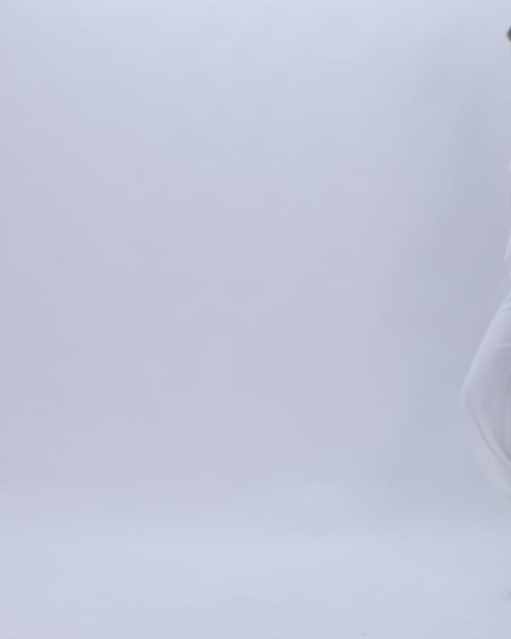 A white evening wear set featuring a high-collar lace top with flared sleeves paired with flared pants.