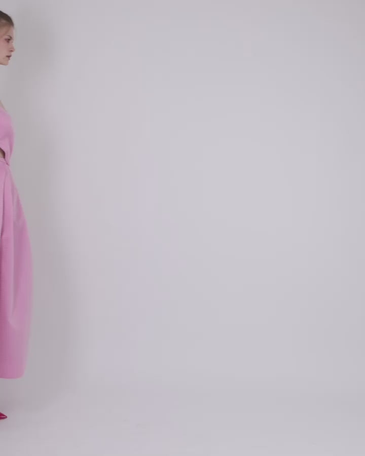 An off-shoulder pink jacquard dress with draping and cut-out details on the sides.