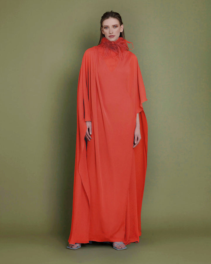 A loose cut chiffon evening dress in orange color with cape-like sleeves, paired with a detachable feathered neckline.