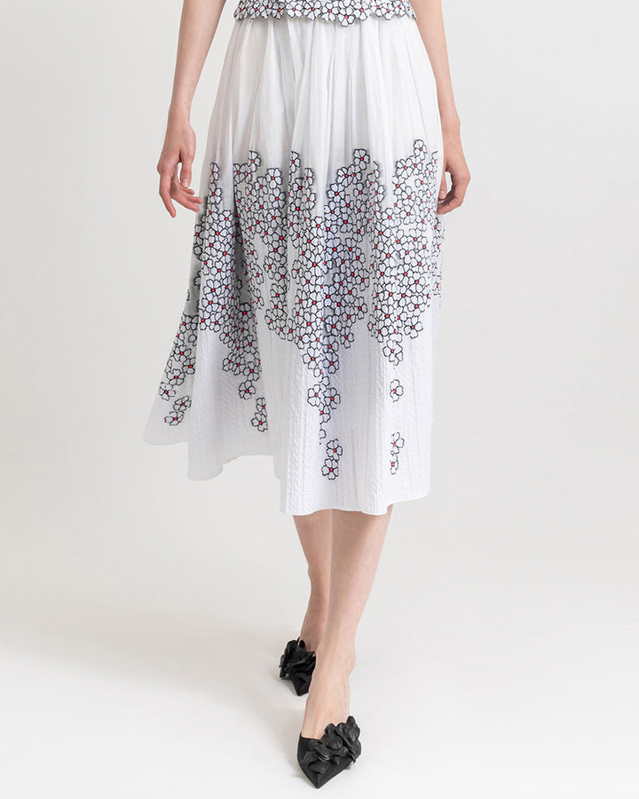 White jacquard midi flared skirt with floral motifs.