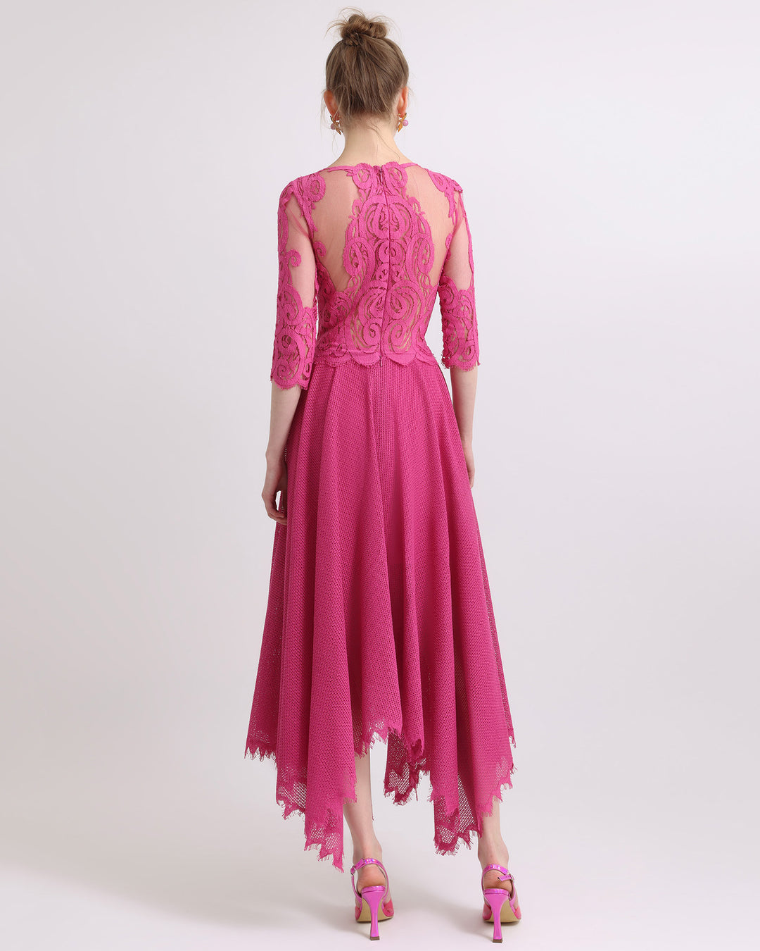 The back of a wide V-neckline with intricate lace flared midi dress in fuchsia color.