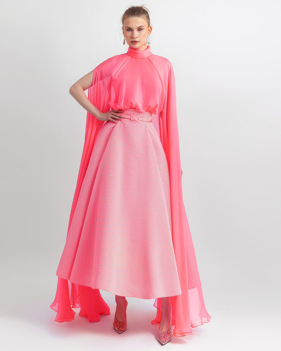 An occasion wear featuring High-neckline pink top with long sleeves paired with flared jacquard neon pink midi skirt and a detachable belt.