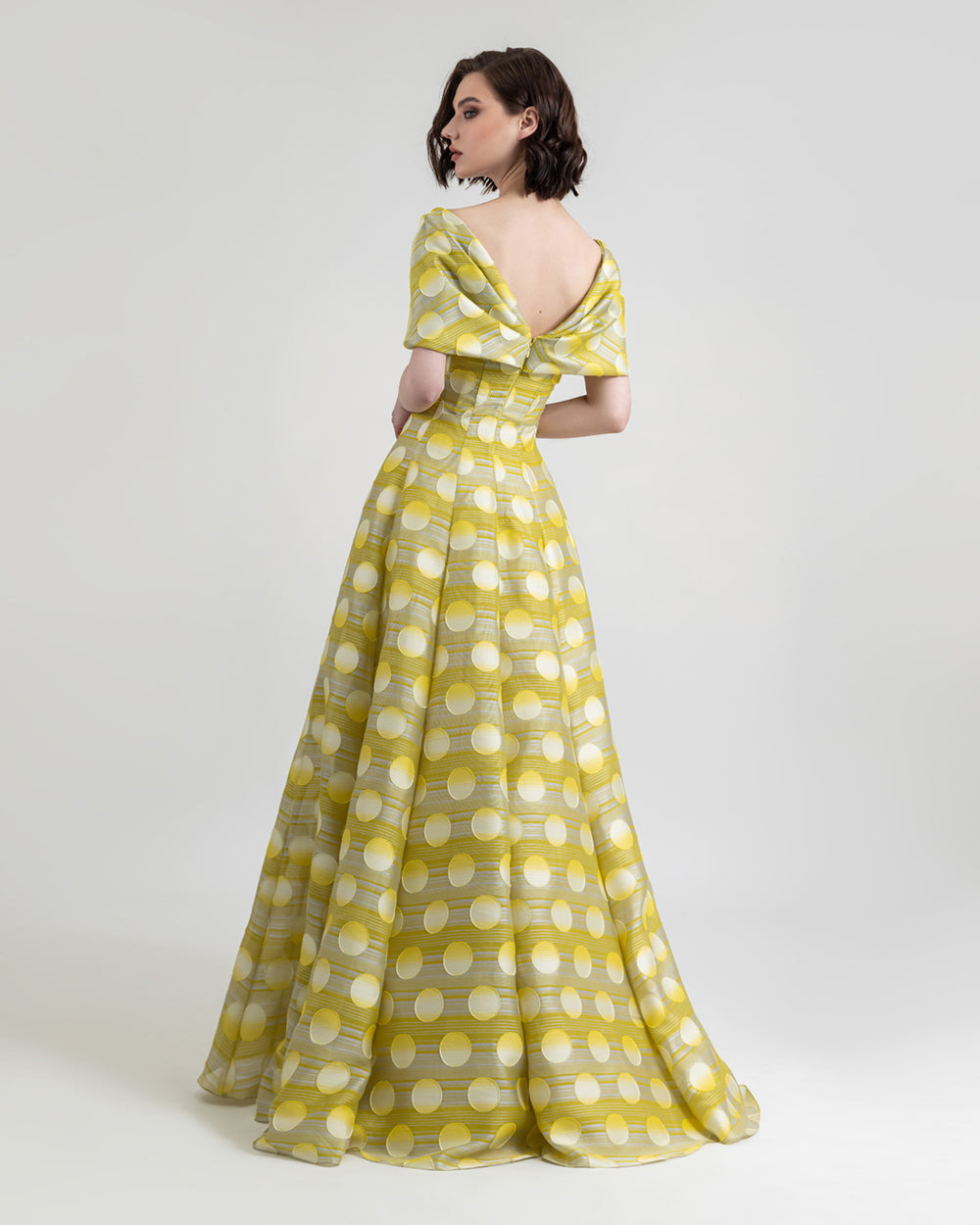 The back of a bow-like upper part flared yellow evening dress.